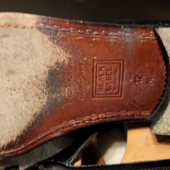 Men black leather loafers with tassles.